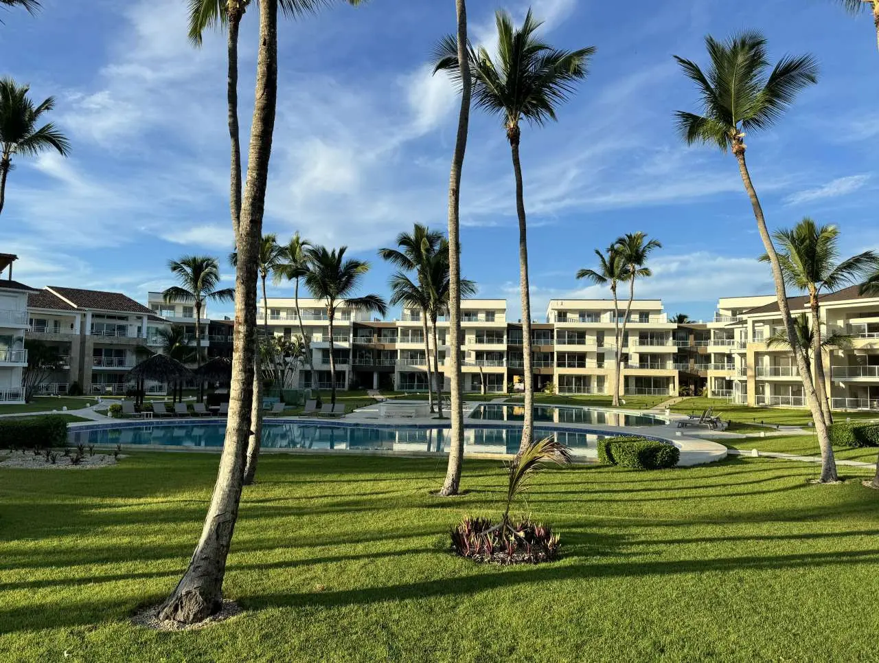 Morning view of Ocean View Apartments, pool, palm trees and green spaces